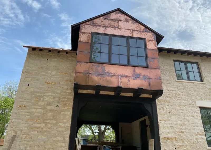 Copper metal panel facade on a stone building for Skylight Installation in Mead